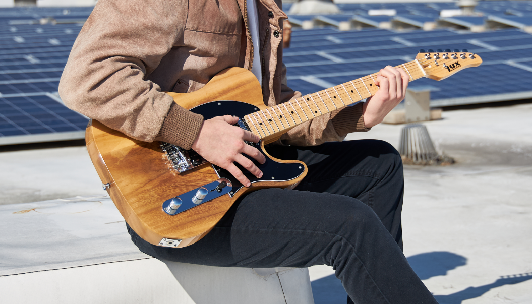 person playing beginner electric guitar 