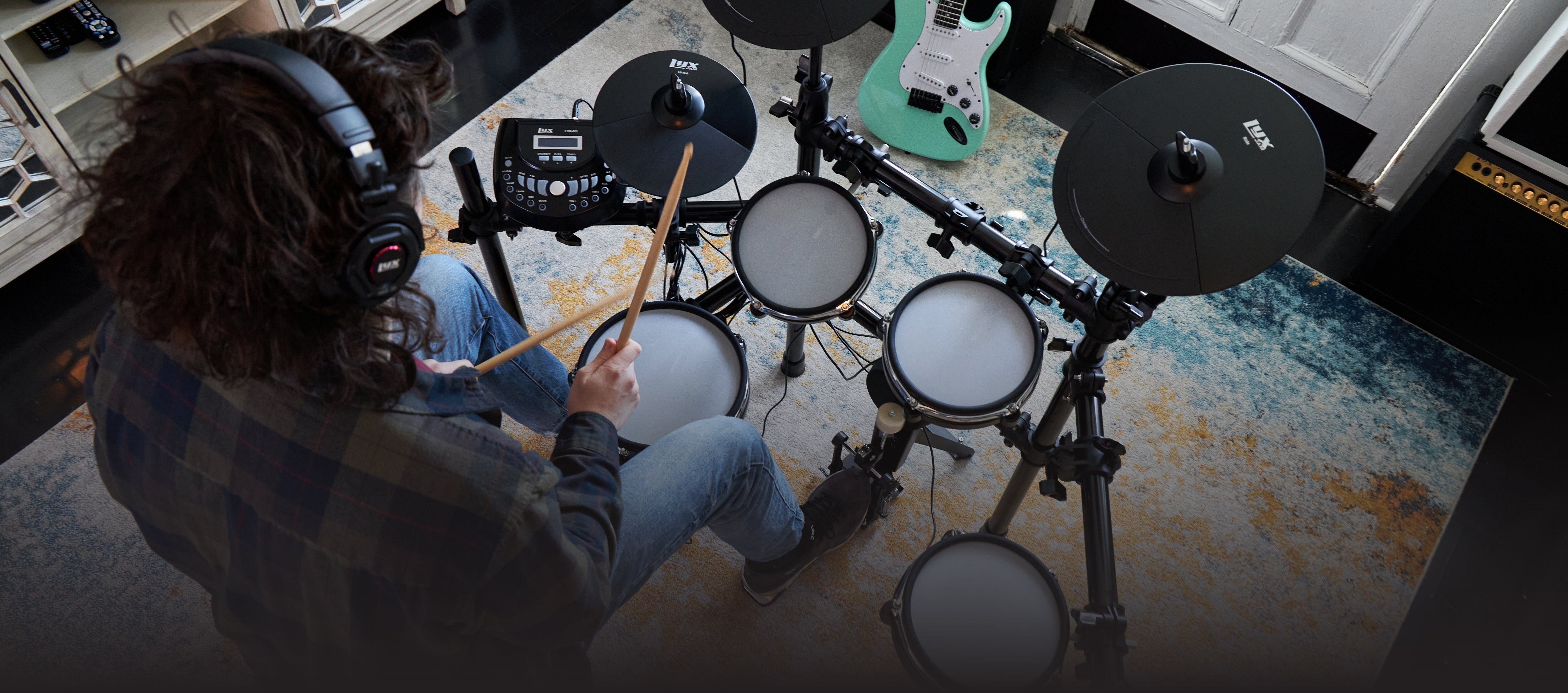 a person playing on the beginner electric drum set 