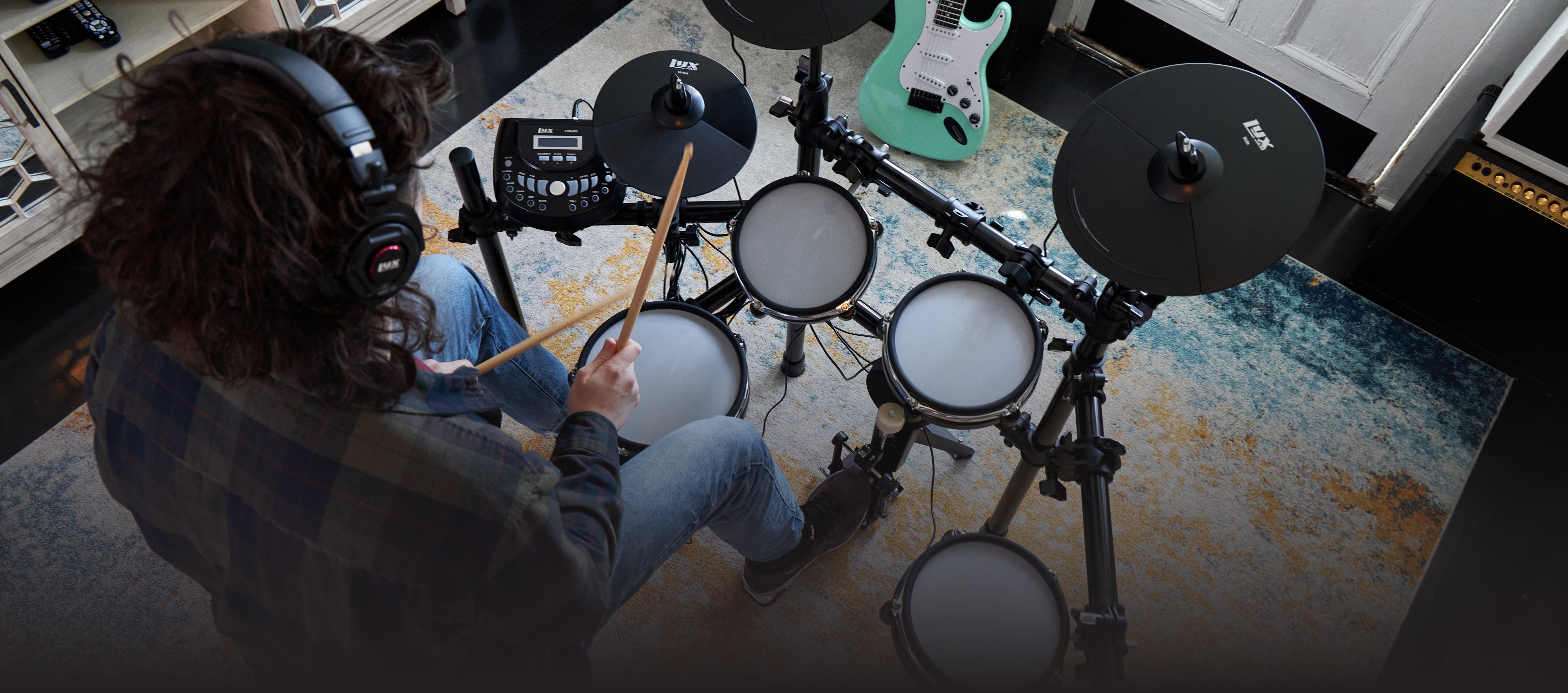 a person playing on the beginner electric drum set