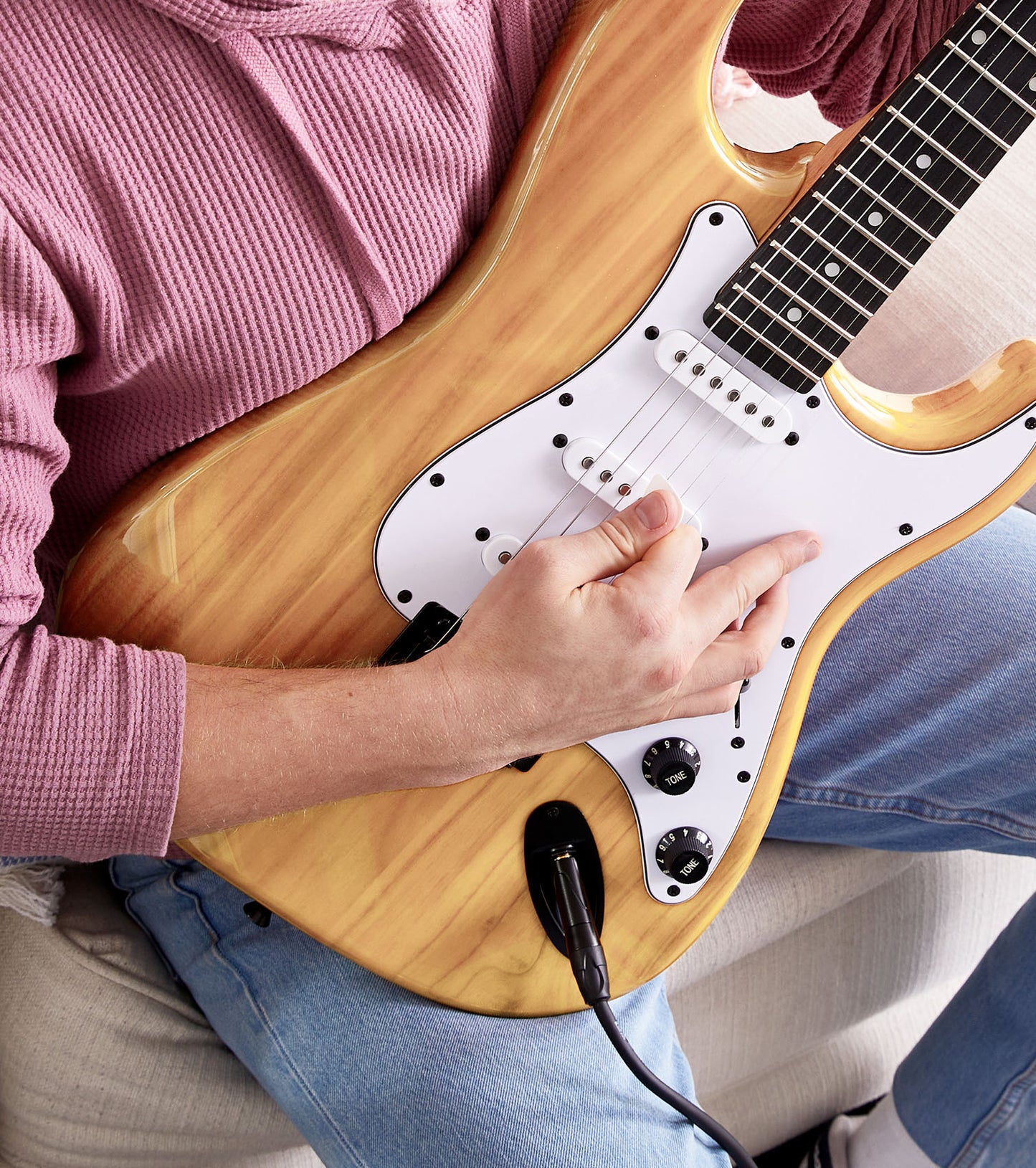 person playing Natural beginner electric guitar