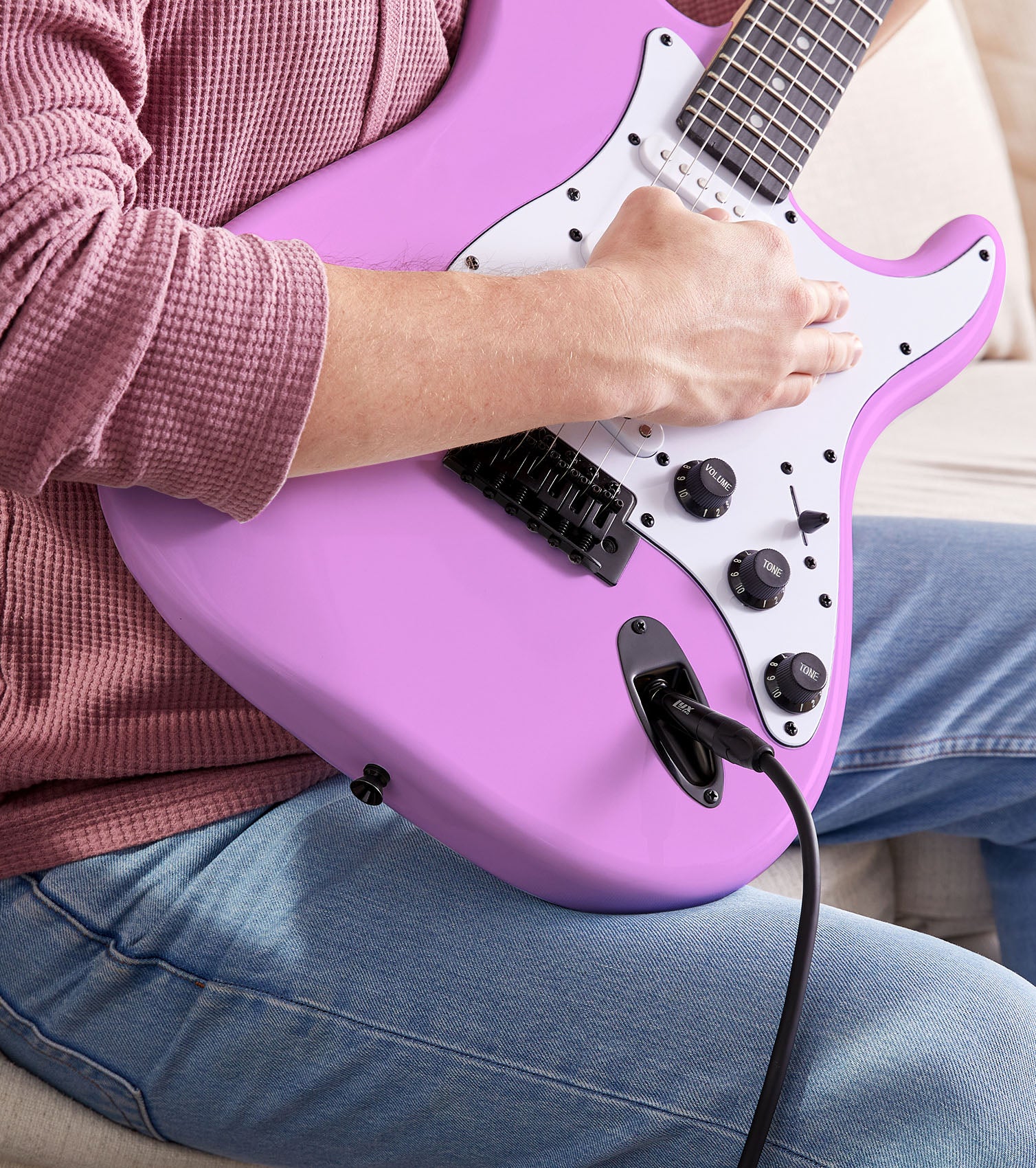 person playing Retro Purple beginner electric guitar