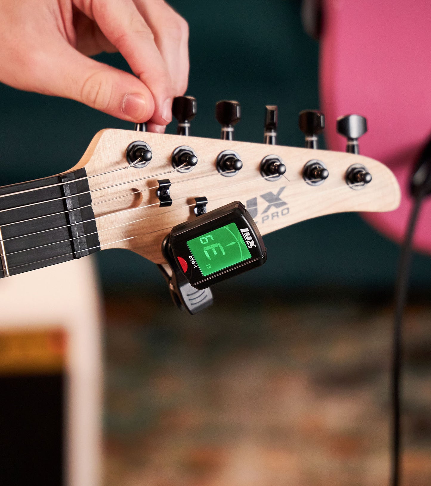 close-up of 39” White beginner electric guitar with tuner