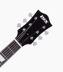 close-up of black les paul inspired electric guitar head