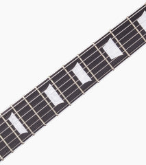 close-up of Sunburst les paul inspired electric guitar fretboard