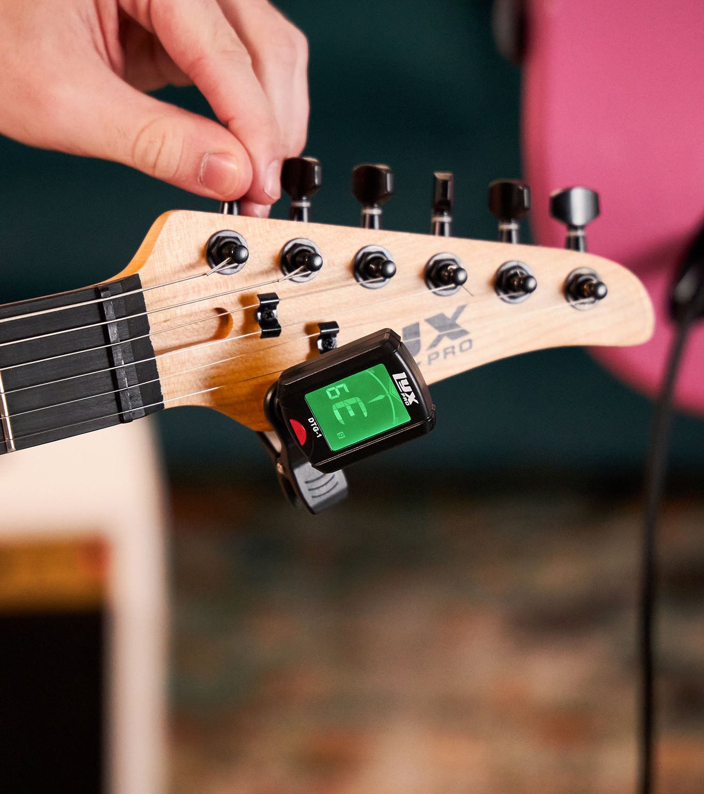 close-up of 30” red beginner electric guitar with tuner