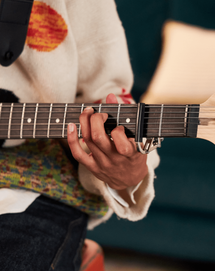 a person playing the beginner electric guitar  