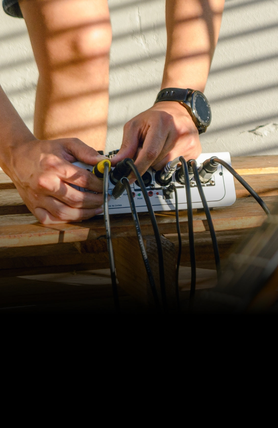 a person plugging audio cables in