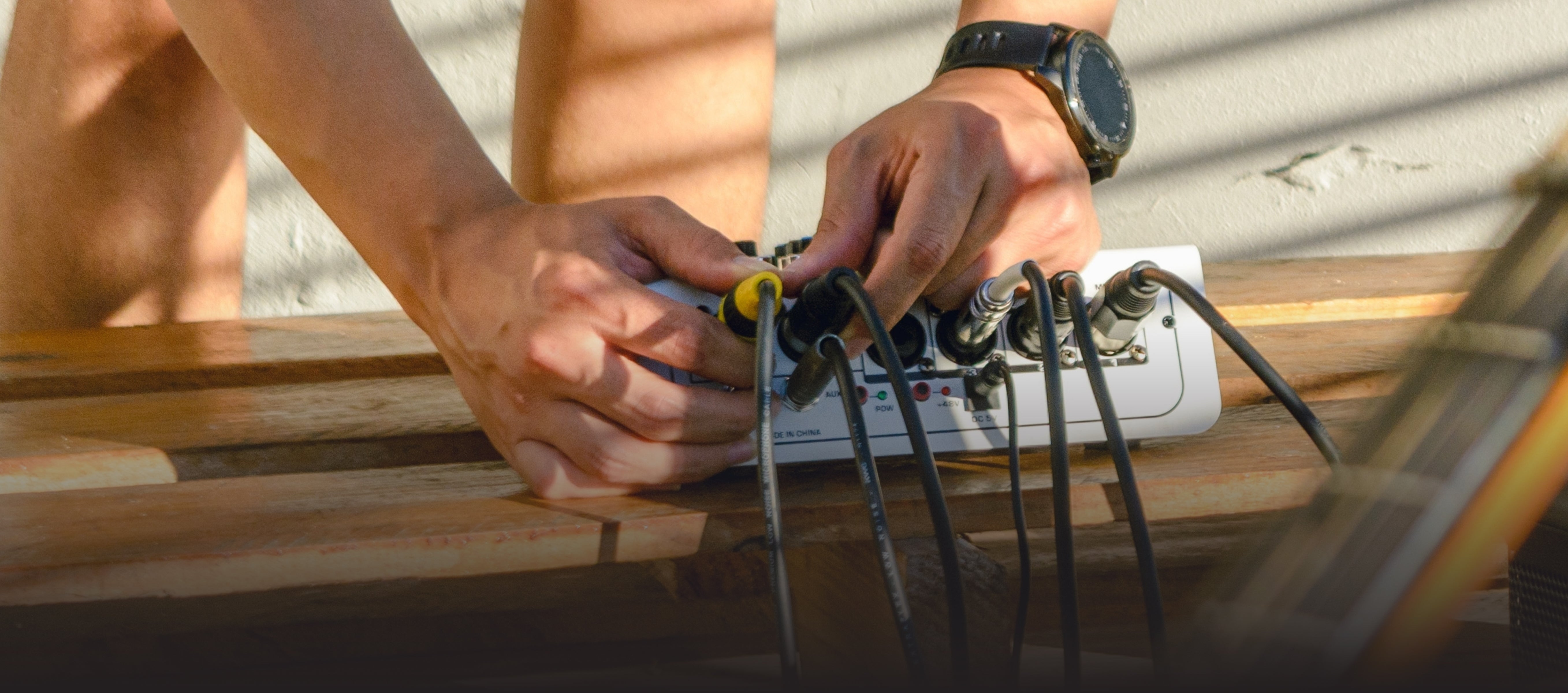 a person plugging audio cables in