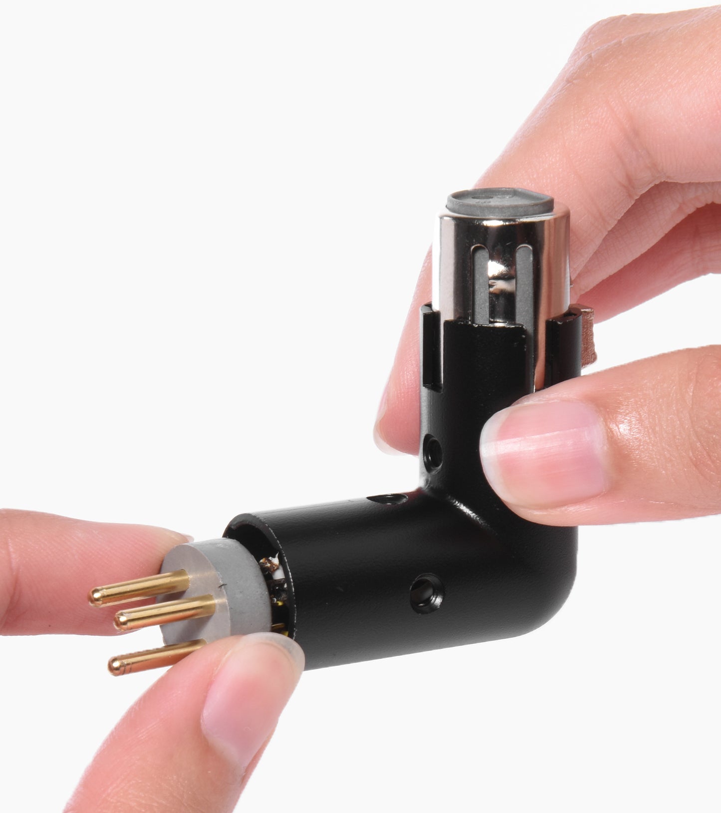 person holding the adjustable right angle XLR adapter 