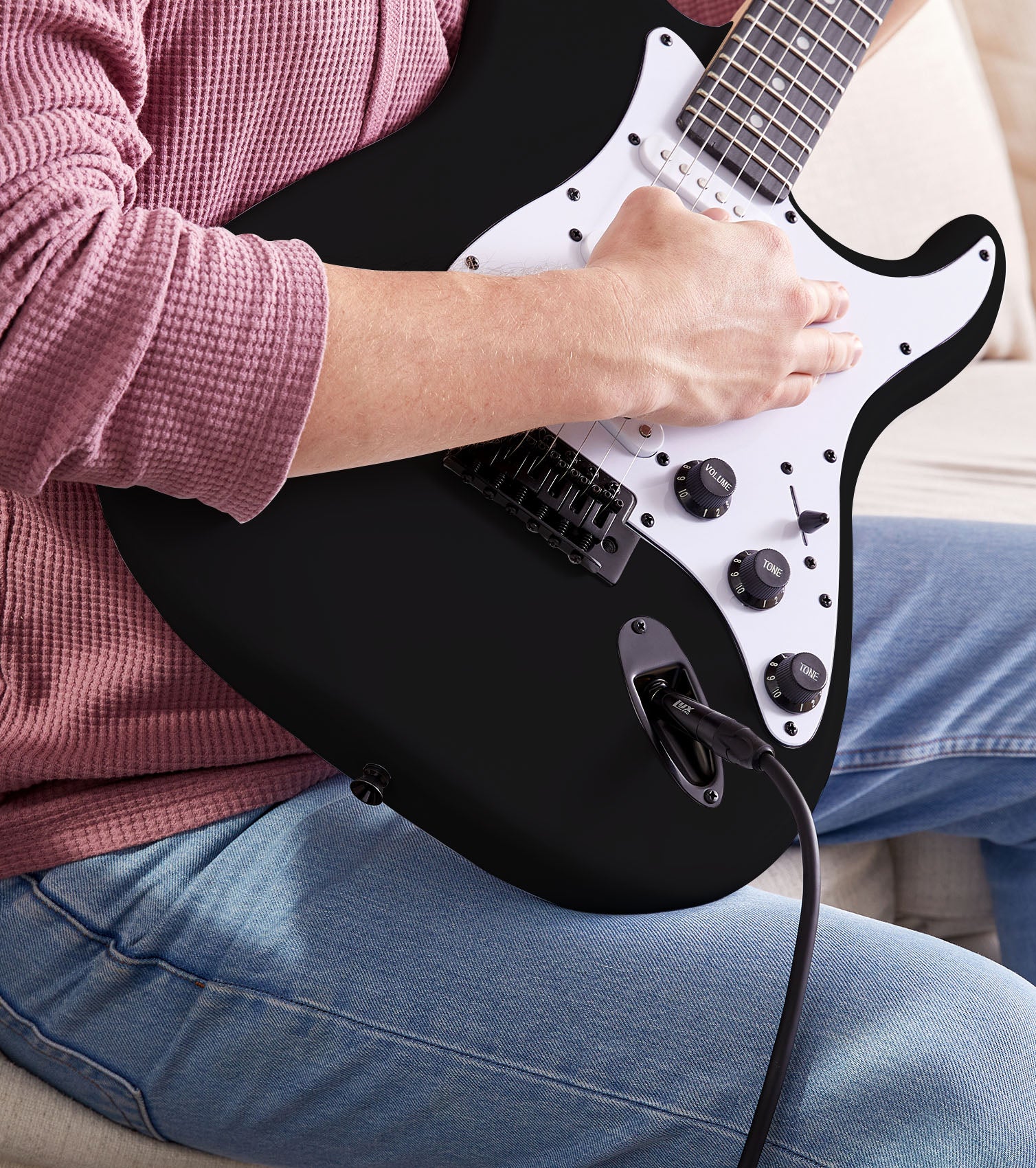 person playing black beginner electric guitar  