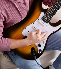 person playing Sunburst beginner electric guitar