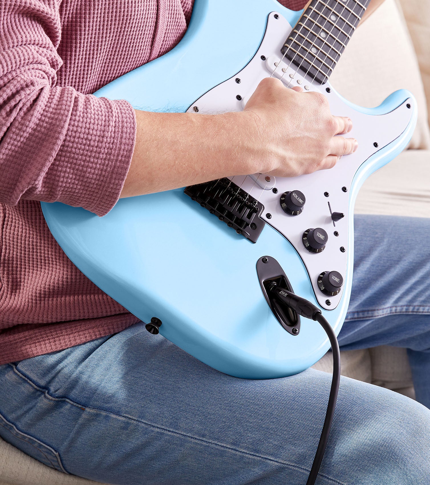 person playing Retro Blue beginner electric guitar