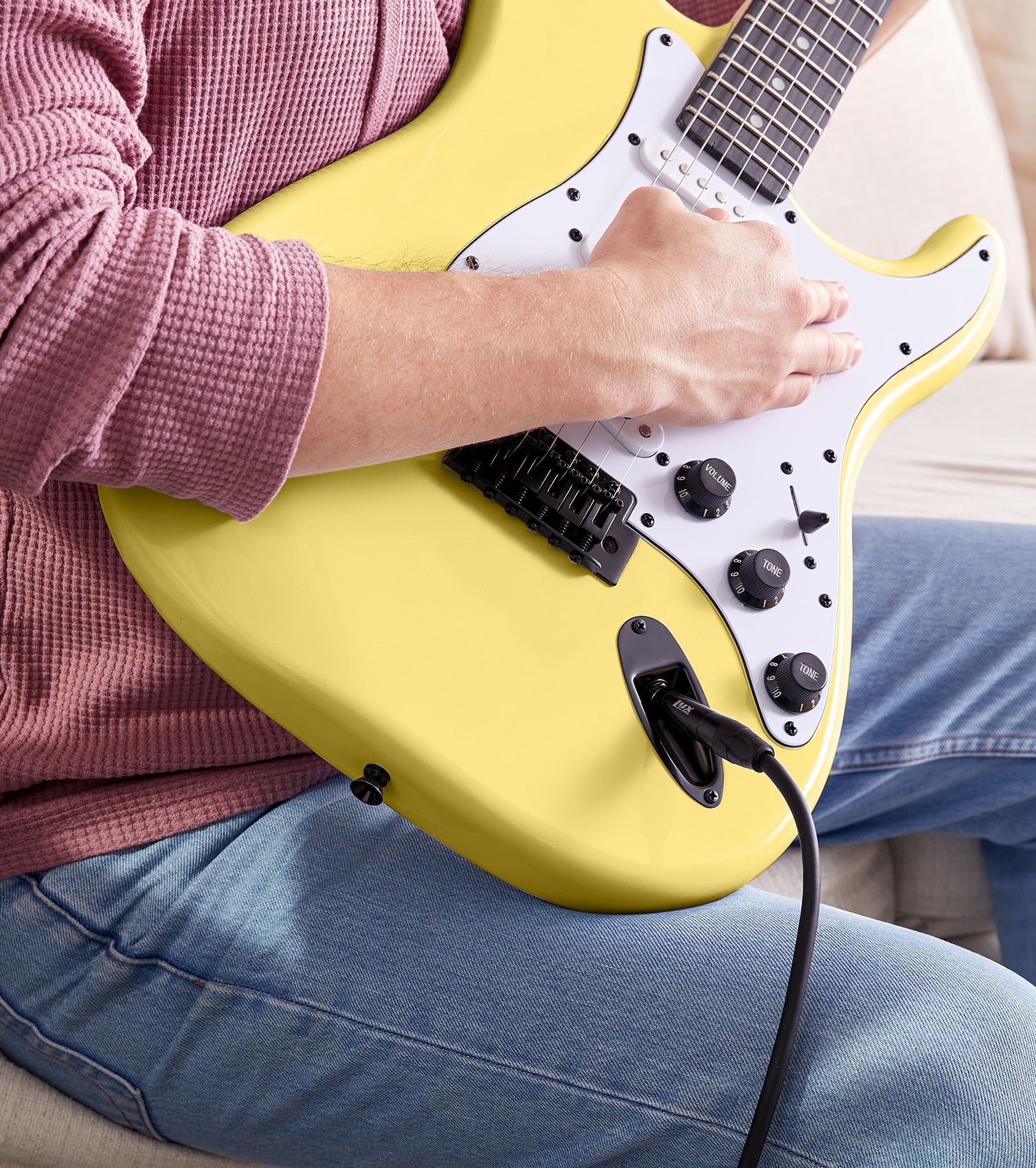 person playing Retro Yellow beginner electric guitar