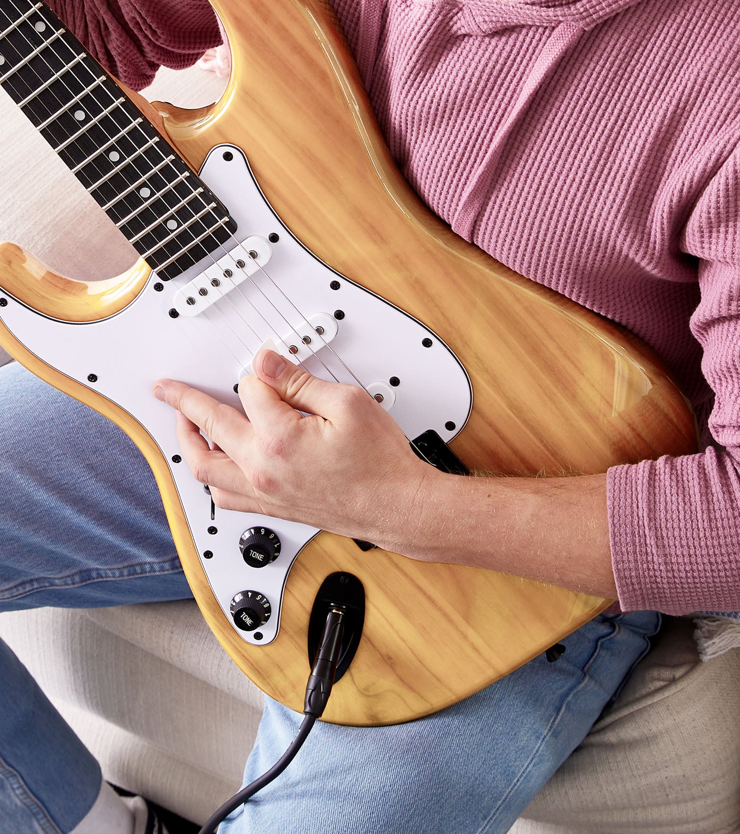 person playing Left Handed Natural beginner electric guitar