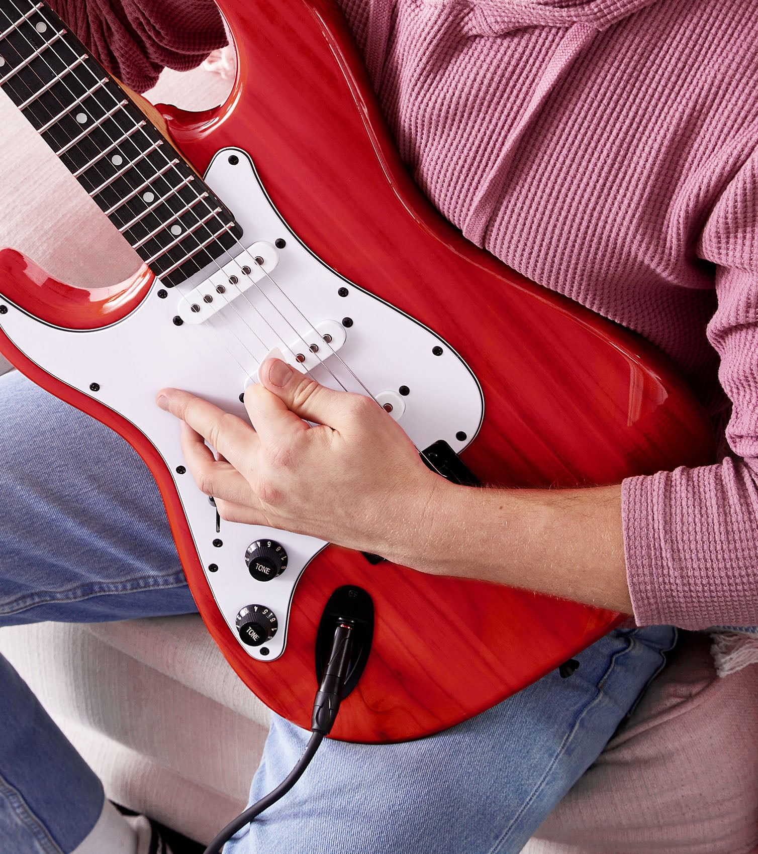 person playing Left Handed Red beginner electric guitar