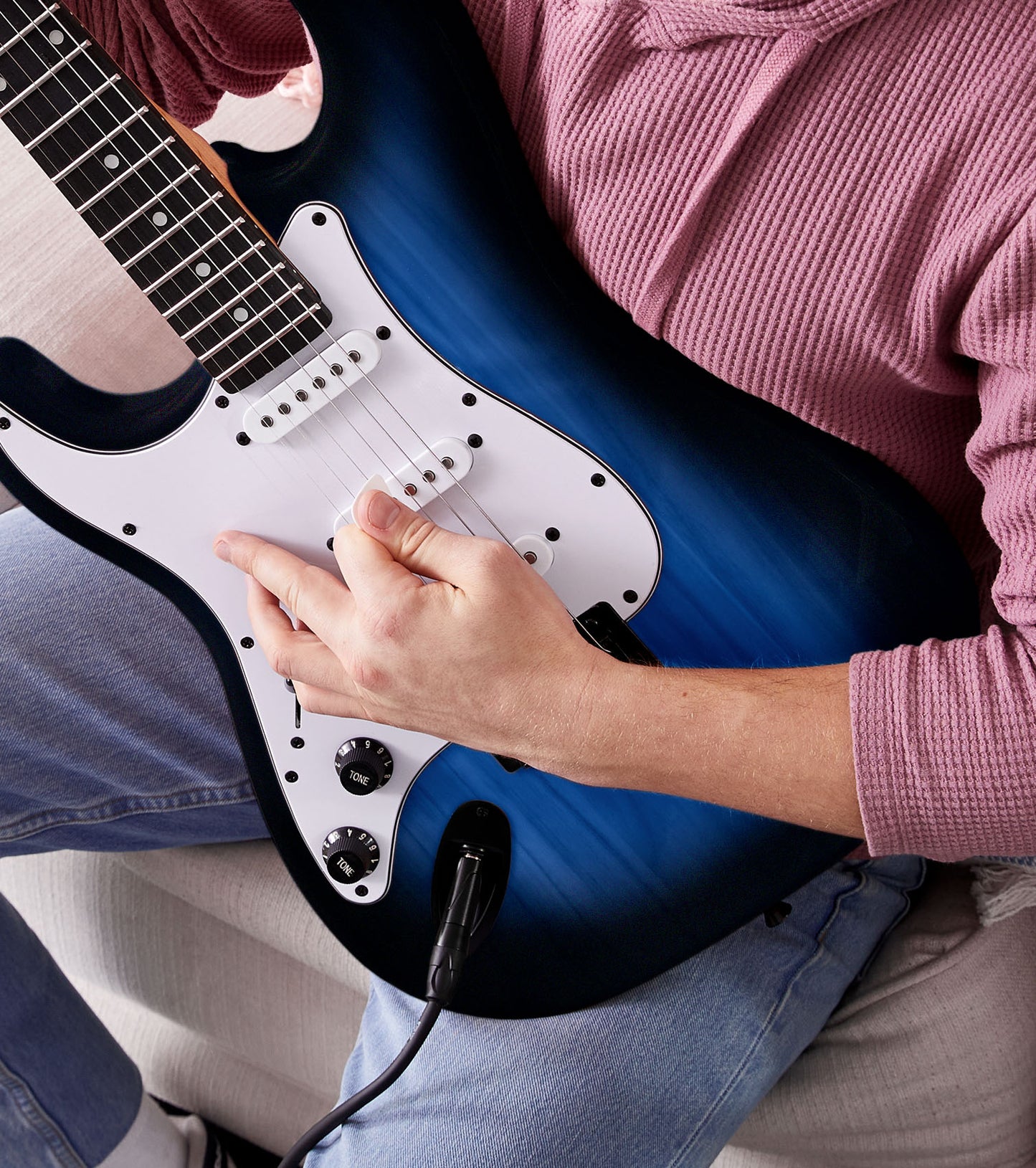 person playing Left Handed Blue beginner electric guitar