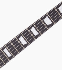 close-up of Green Left Handed les paul inspired electric guitar fretboard