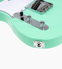 close-up of a Green Left Handed single-cutaway electric guitar audio port