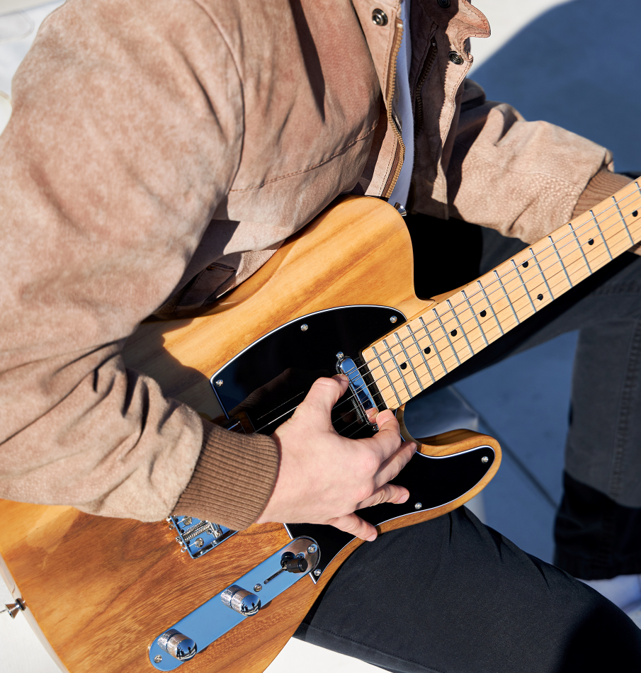  a person playing the beginner electric guitar 