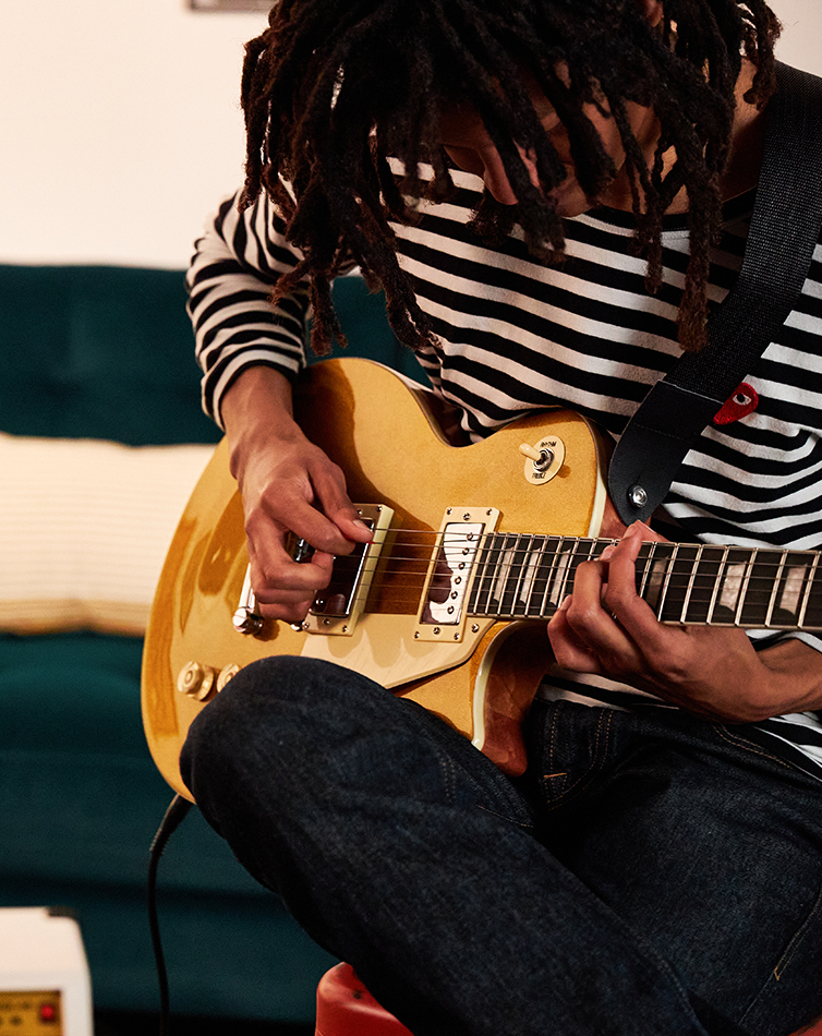 a person playing the beginner electric guitar 